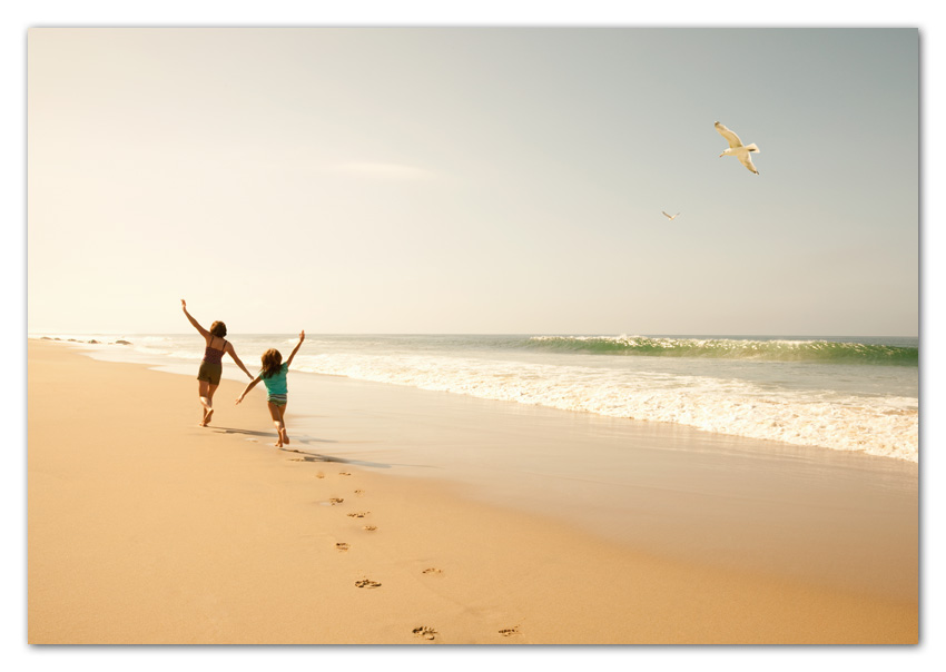 01Stock Mother and daughter running on beach with arm spread Lagguna Beach California