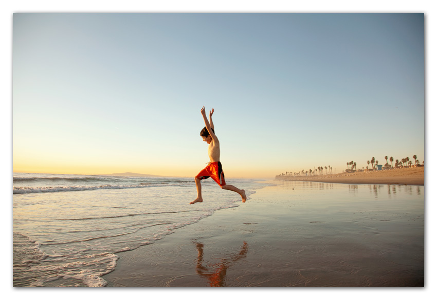 07Stock Boy running beach into ocean Huntington Beach California