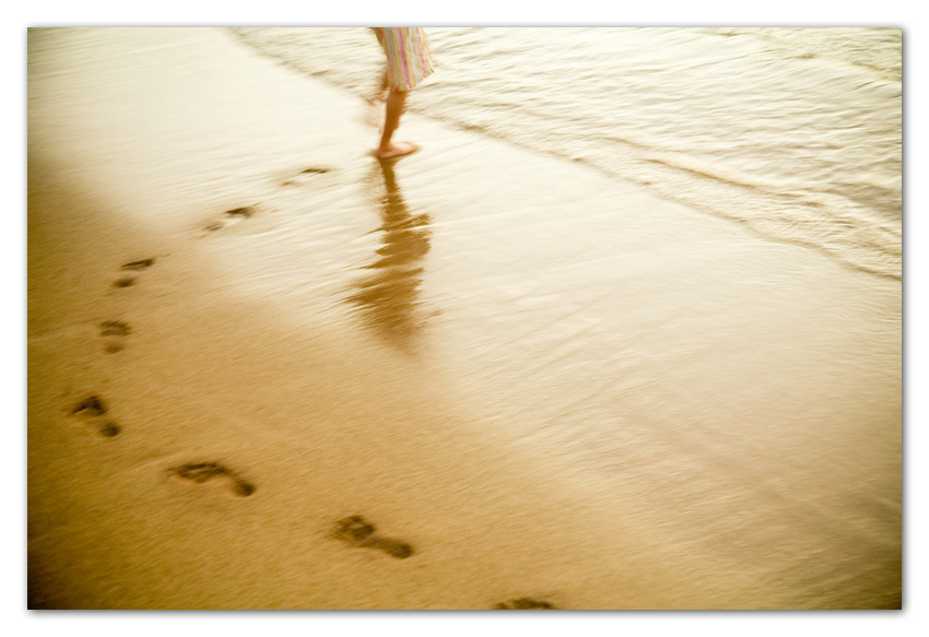 Kauai009 Girl running on beach with footprints on sands Kapaa Kauai Hawaii